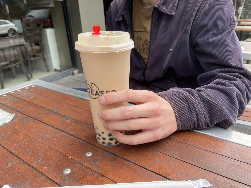 Man holding a cup of bubble milk tea in the US